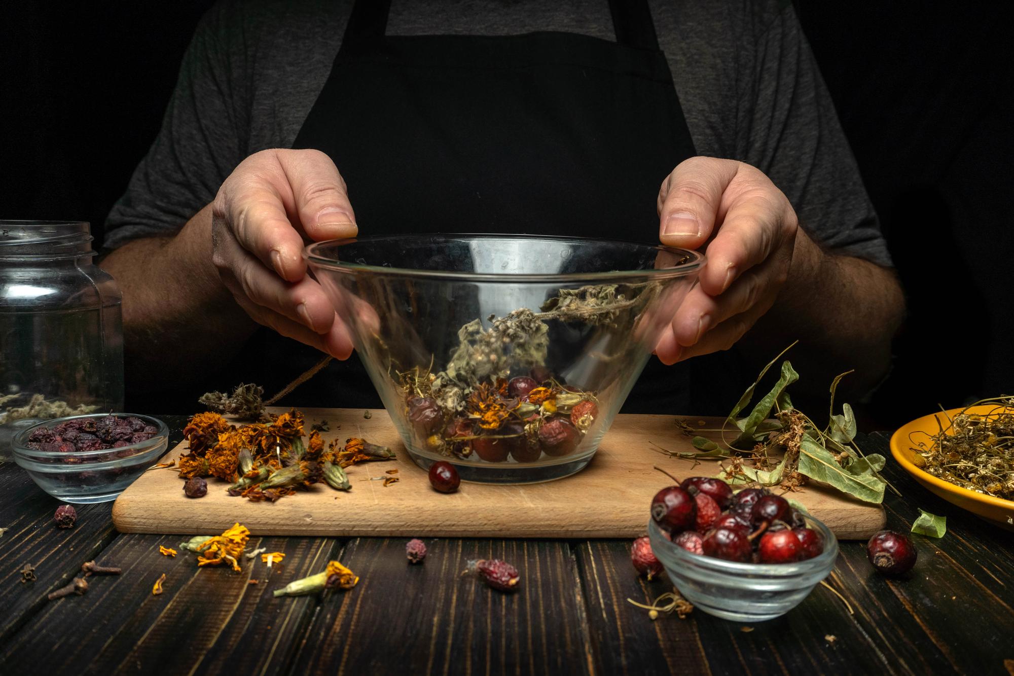 Chef arranging herbs in a copper pan
